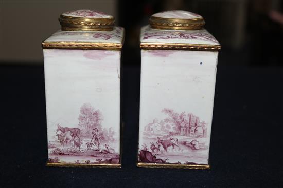 A pair of South Staffordshire enamel tea caddies and covers, and two similar candlesticks, late 18th century, 6.25in. and 10in., candle